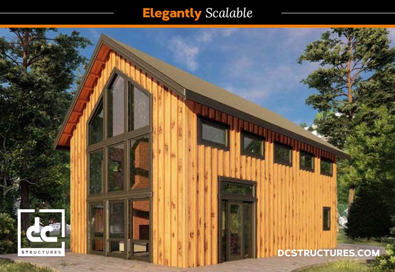 A modern, two-story wooden house with large windows and a steep, gabled roof. Surrounded by trees under a clear blue sky, the design emphasizes natural light and spaciousness. Inspired by our small barn home kit, branding elements include "Elegantly Scalable" and "dcstructures.com.