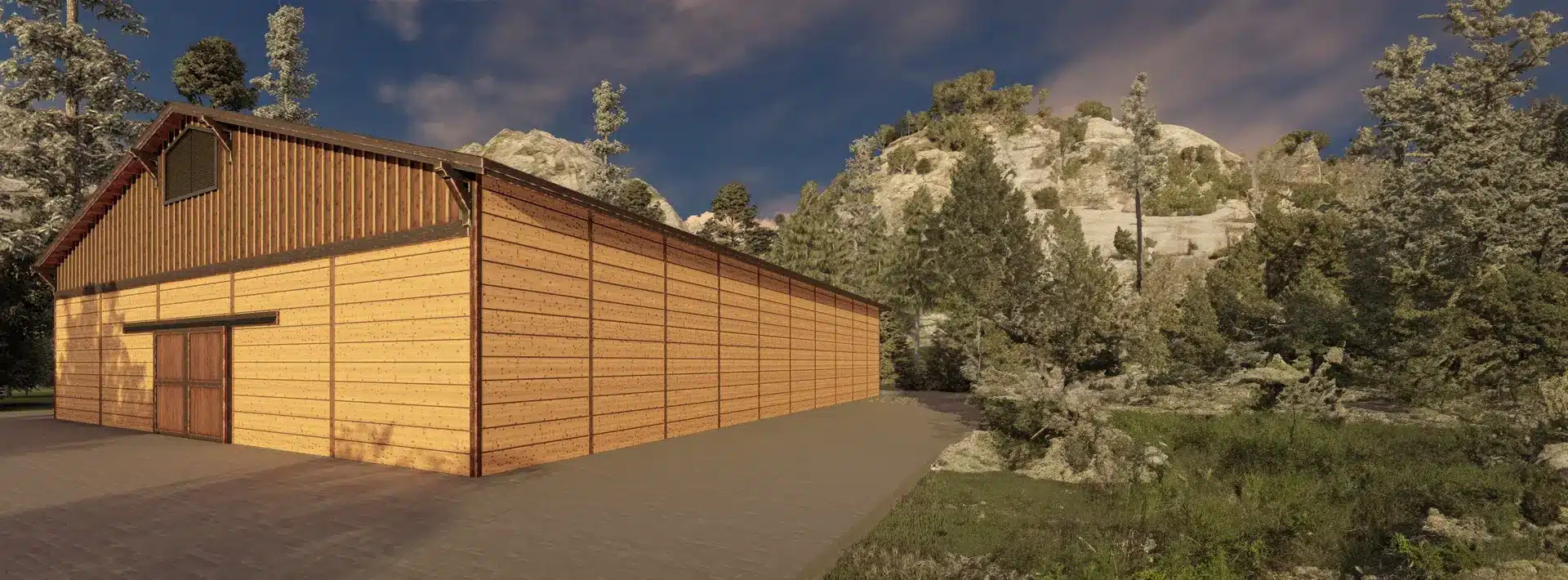 A large wooden barn with vertical and horizontal planks stands by a paved path, surrounded by green trees, shrubs, and rocky hills.