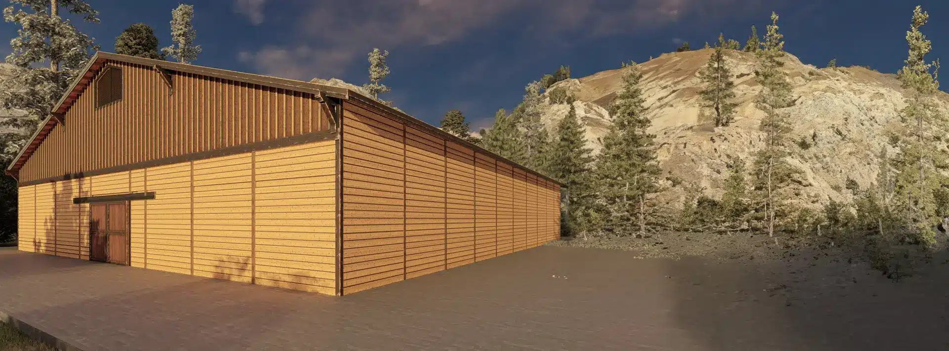 A large wooden building with vertical and horizontal paneling sits on a gray paved area, surrounded by pines and rocky hills.