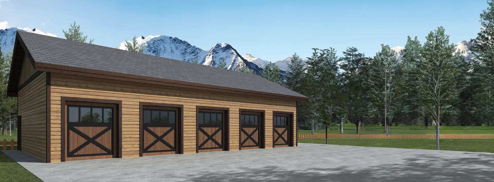 A large wooden garage with four barn-style doors stands on a concrete driveway, surrounded by trees, grass, and mountains.