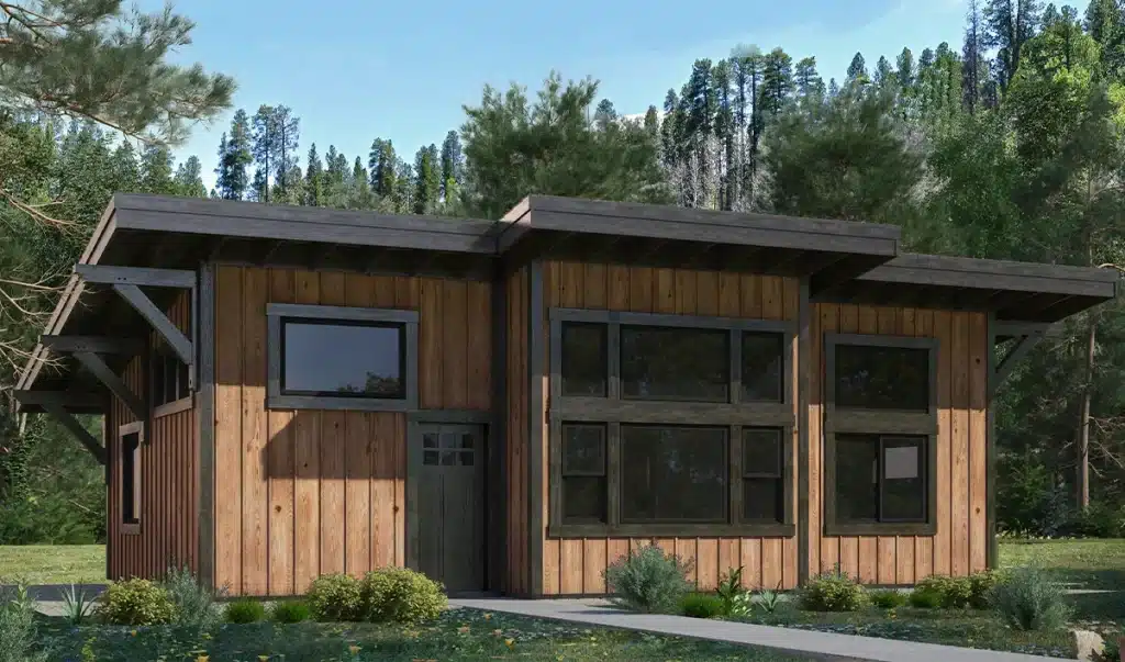Modern cabin with vertical wood siding, large dark-framed windows, and a flat multi-level metal roof, surrounded by trees and greenery.