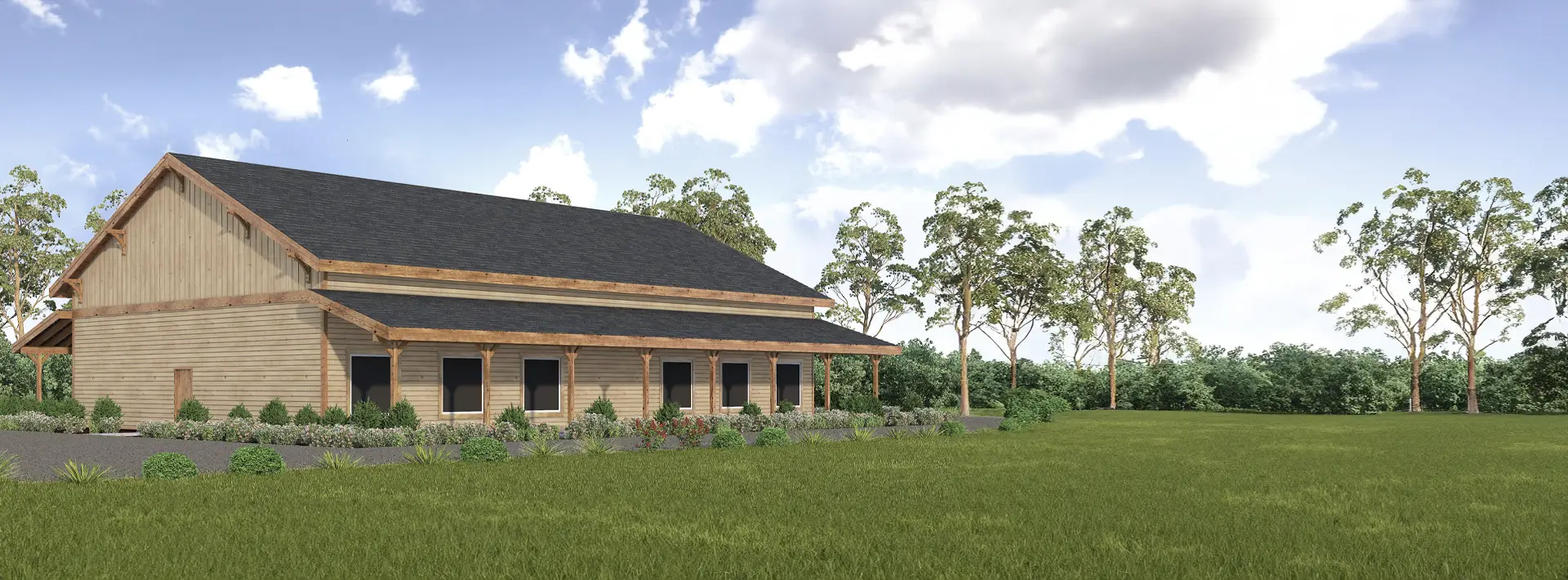 A large wooden barn-style building with a dark roof sits on a grassy lawn, surrounded by trees under a partly cloudy sky.