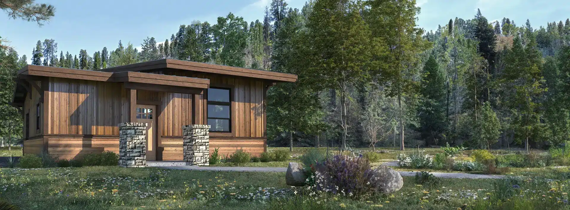 A small modern wooden cabin with large windows and stone pillars sits in a grassy clearing among lush trees and wildflowers.