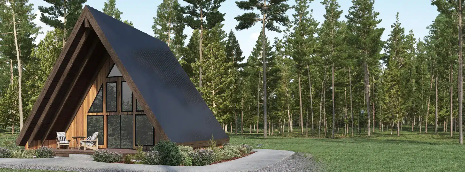 A modern A-frame cabin with large glass windows and a dark sloped roof sits among tall pines. Two chairs are on the porch.