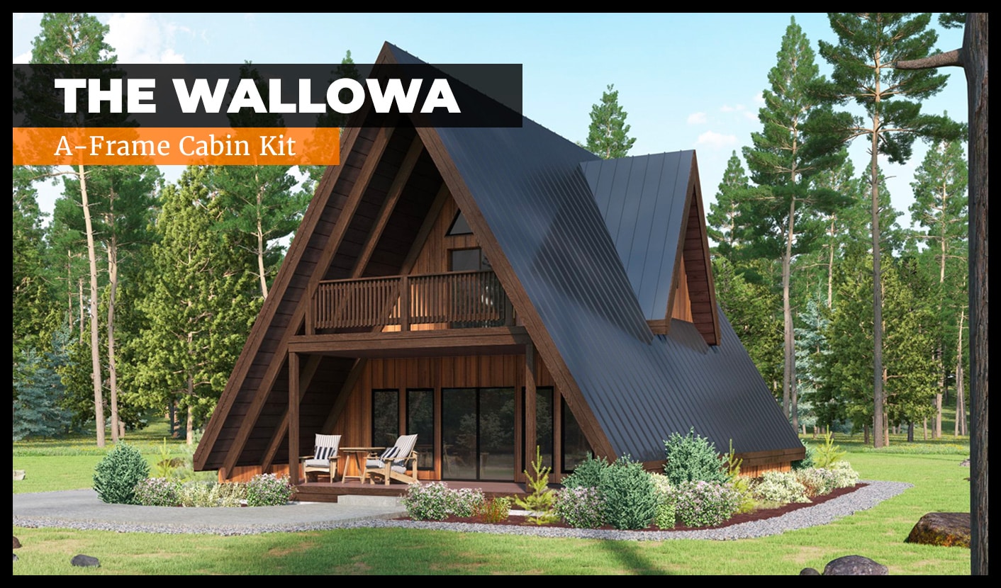 A-frame wooden cabin surrounded by trees, featuring a small front porch with chairs. The cabin has large windows and a balcony. A sign reads "The Wallowa A-Frame Cabin Kit.