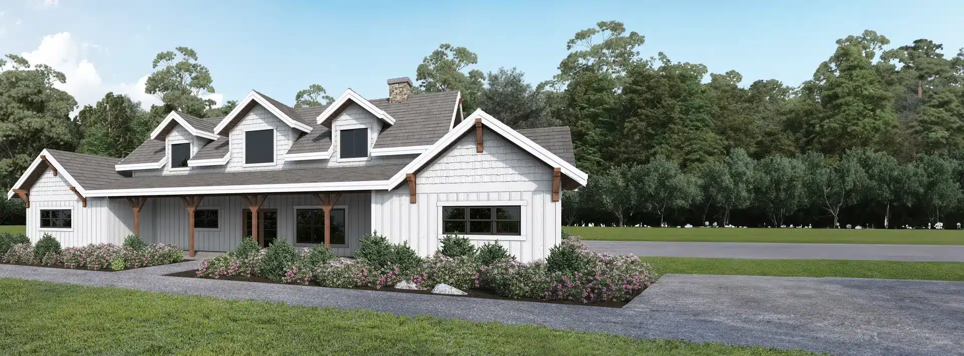 A white farmhouse with gray roof, dormer windows, and wooden beams stands beside a garden with shrubs and flowers under a blue sky.