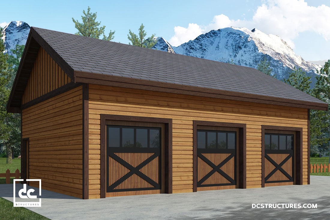 A wooden three-car garage with pitched roof, featuring dark trim around each door. Snow-capped mountains and trees are visible in the background under a partly cloudy sky. Branding from DC Structures is visible in the bottom corners.