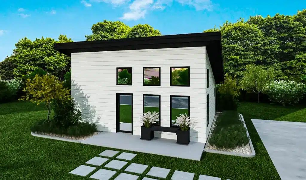 Modern tiny house with white horizontal siding, large black-trim windows, slanted roof, lush lawn and trees. Pavers to door.
