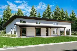 Modern single-story house with a slanted roof, large windows, and white siding, surrounded by green grass and tall pine trees under a blue sky.
