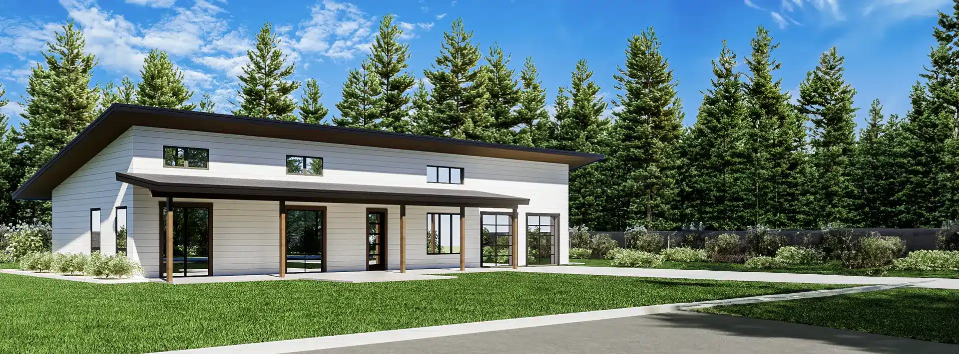 Modern single-story house with large windows, white siding, and a sloped roof, surrounded by grass and trees under a blue sky.