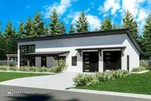 A modern single-story house with large windows, double garage doors, a sloped roof, green grass, shrubs, and tall pine trees under a blue sky with clouds.