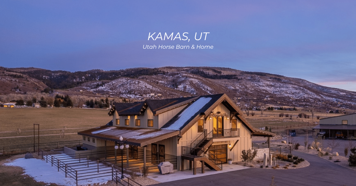 A modern barn-style home in Kamas, Utah, sits in a wide, snowy valley with mountains in the background at sunset.